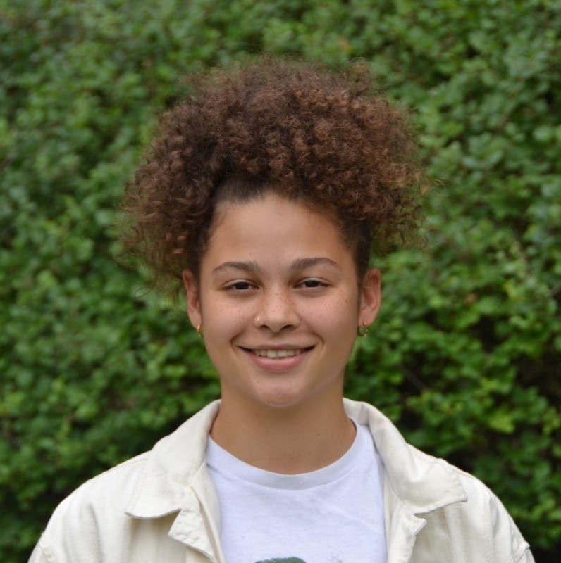 Catherine Driver ’25 poses for a portrait in front of greenery.