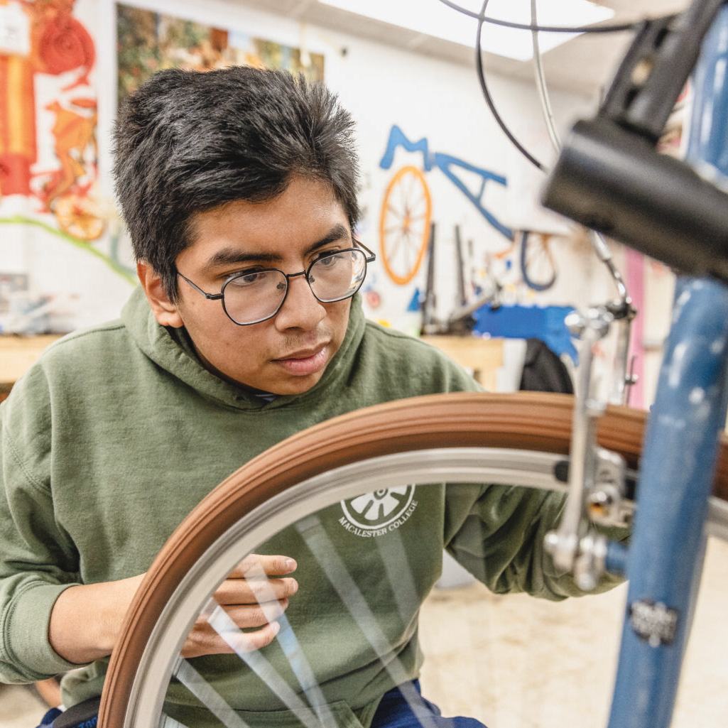 Tomás Prendergast ’27 learns how to fix a bicycle in the campus bike shop, which offers free repairs and bike education to students.