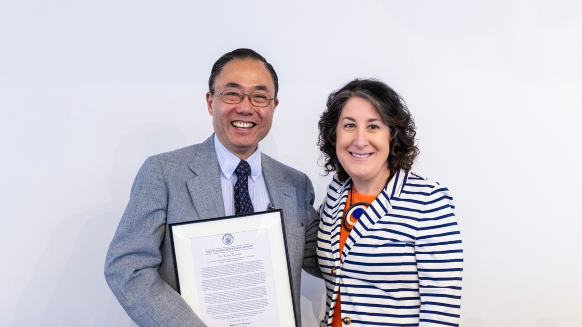 Professor Kuwata stands with President Rivera, holding the Jefferson Award.