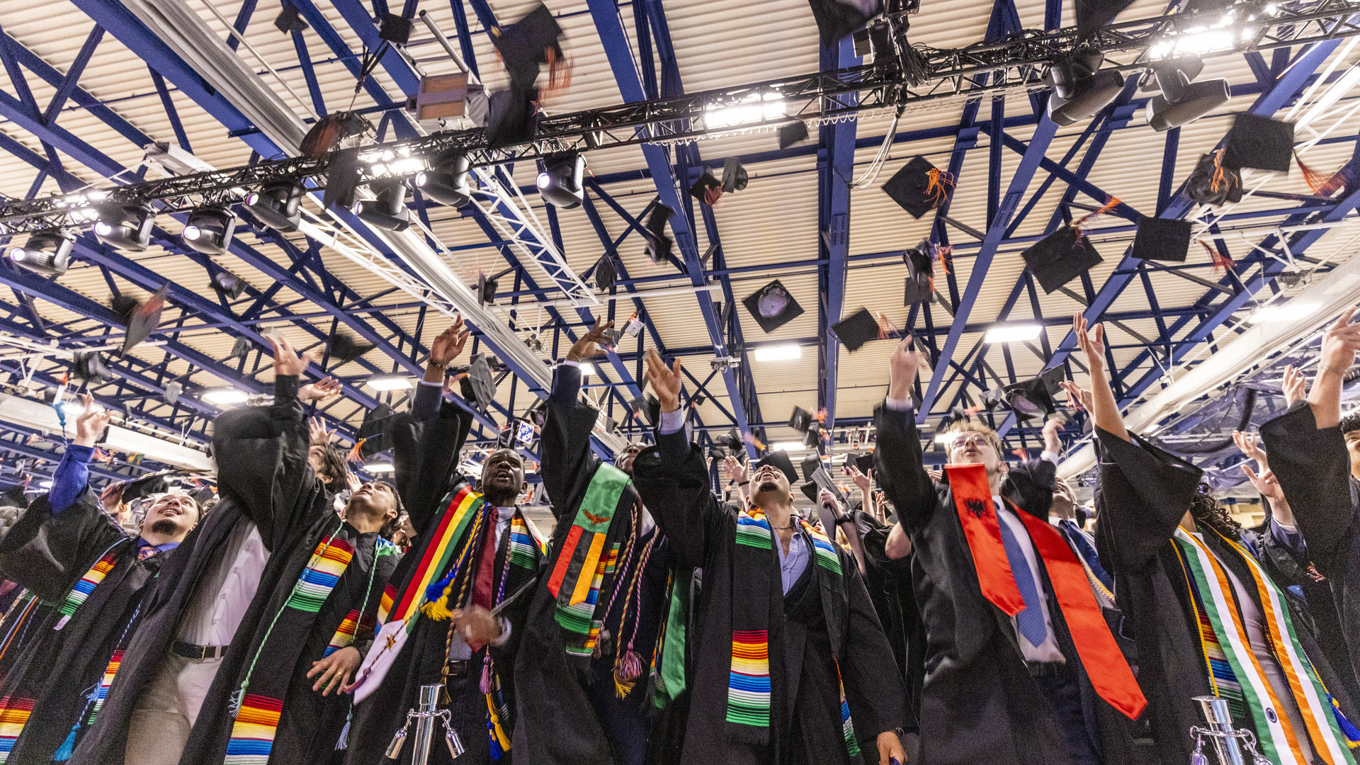 Class of 2026 graduates toss their caps into the air