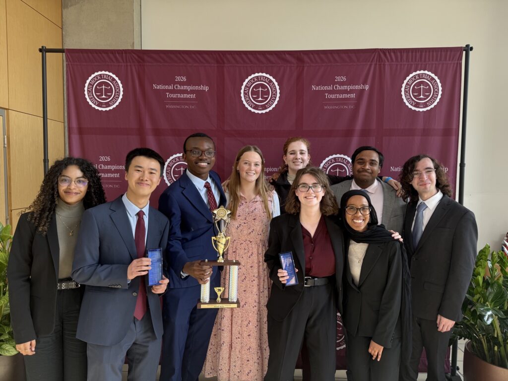 Paramitha Pratha ’29, Jo-Z Wu ’28, Kofi Anyimadu ’28, Betsy Thede ’29, Josie Mitchell ’29, Kate Caulder ’27, Sabri Abdusalam ’28, and Tani Gangal ’29 pose with the honorable mention trophy in front of a maroon backdrop at the American Mock Trial Association’s 41st National Championship Tournament in Washington, DC.