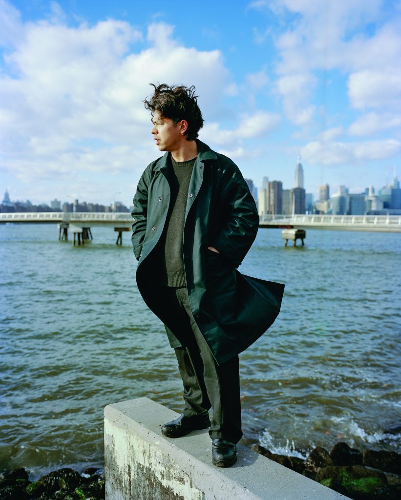 Will Matsuda poses for a photo in front of a harbor in New York.