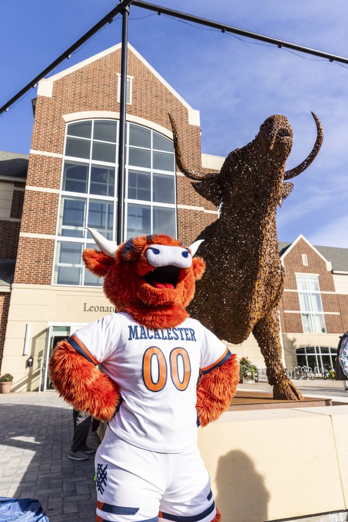 Coo, Macalester's mascot, poises with Coo, the sculpture at the artwork's unveiling during Mac Fest.