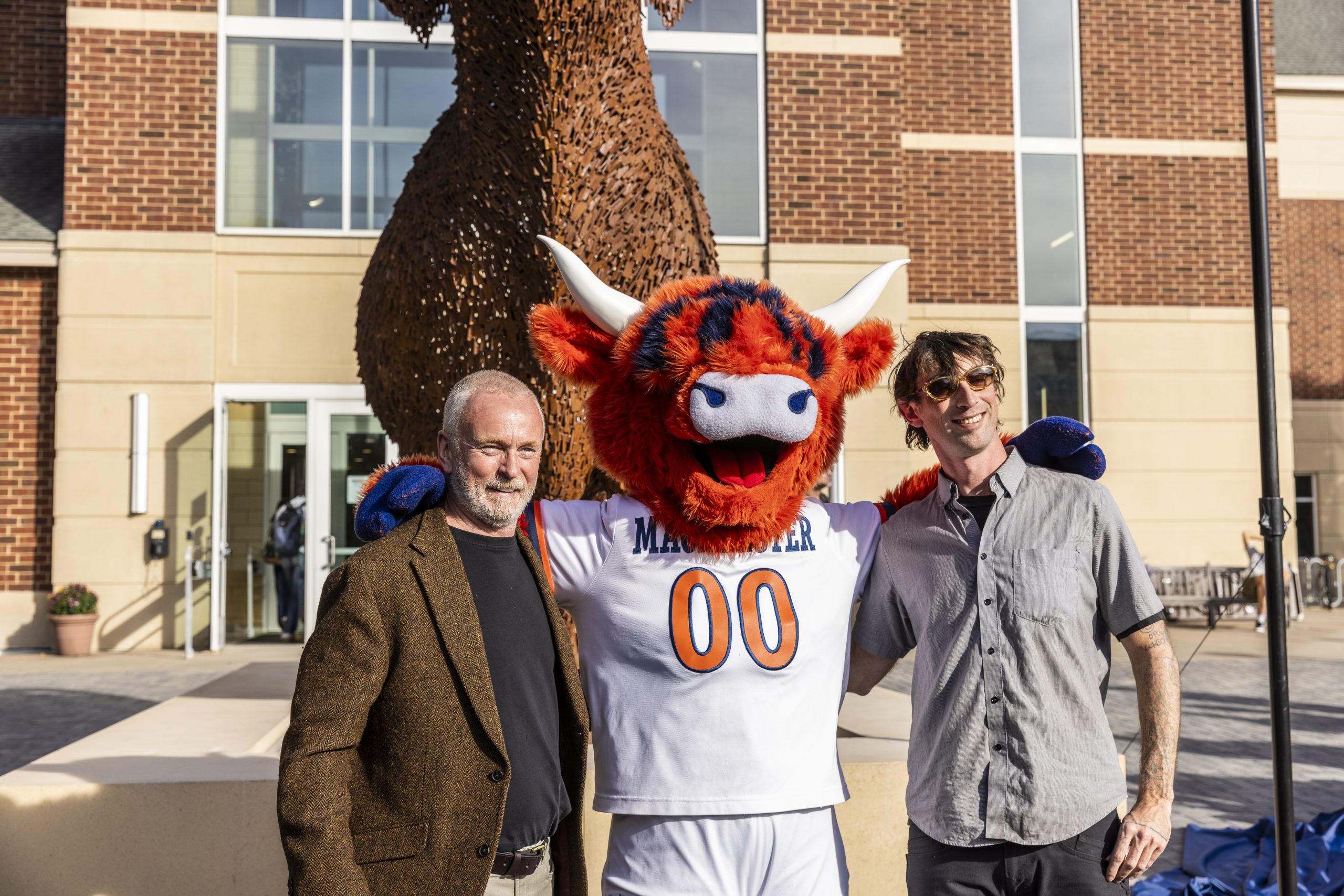 Andy Scott O.B.E. and Rob Little, who assisted in the creation of Coo, pose in front of the new sculpture.