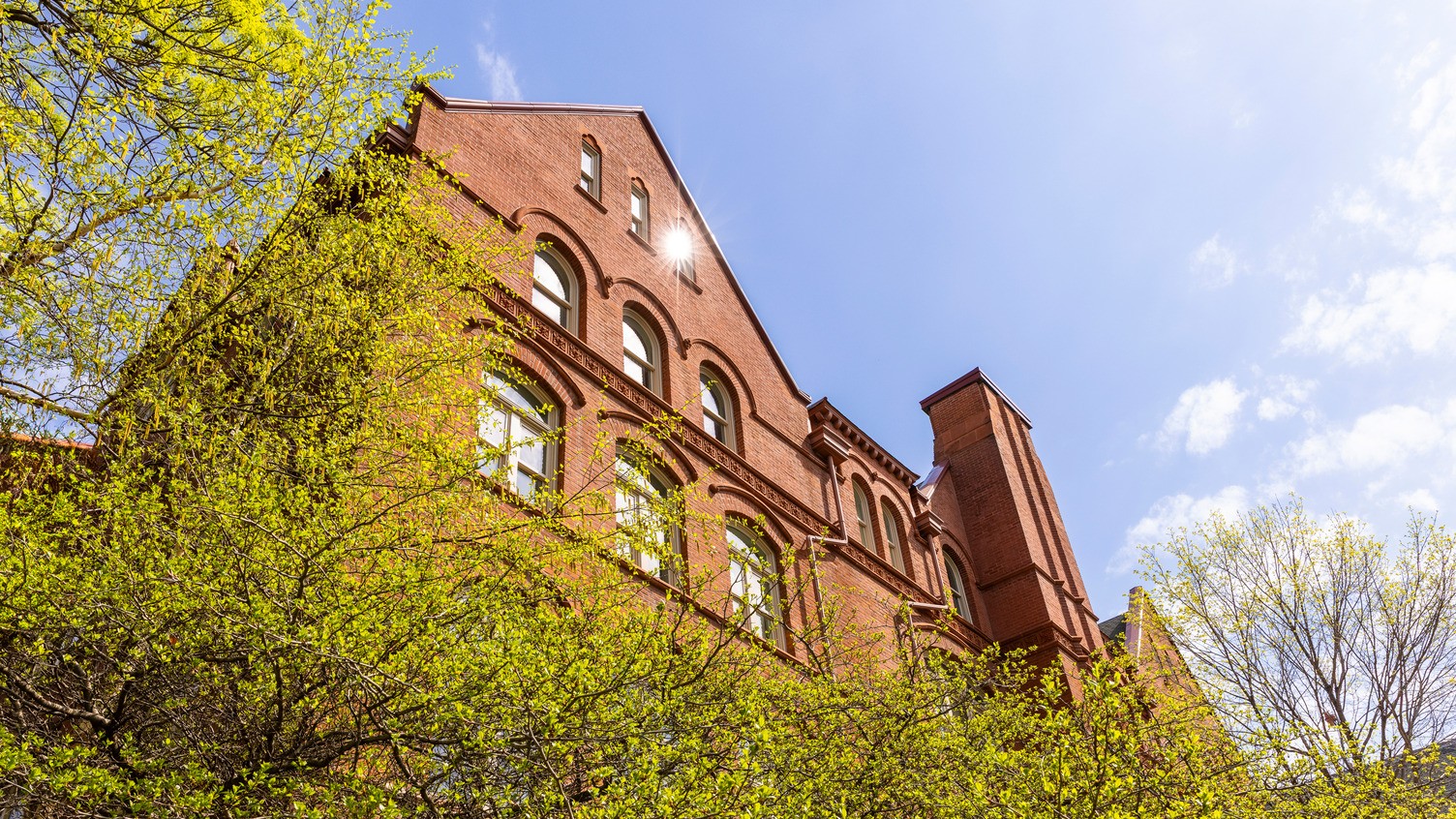 A sunlit Old Main from a low angle