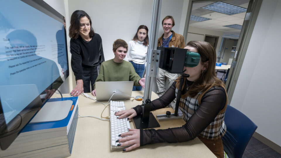 Three students and a professor conduct research