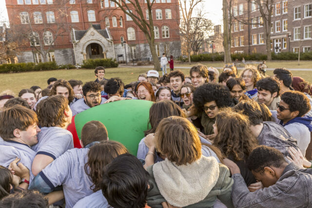 Students push a multicolored pushball across the Great Lawn