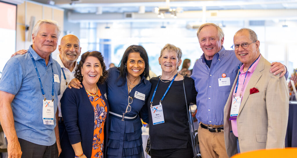 President Rivera poses with six members of the James Wallace Society