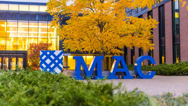 Large sculptural MAC letters with the college's shield