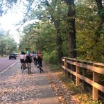 a group of students riding bicycles in the fall along the Mississippi River Road