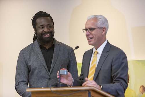 Marlon James and President Brian Rosenberg President Brian Rosenbeg gifts Marlon James his bullshit button