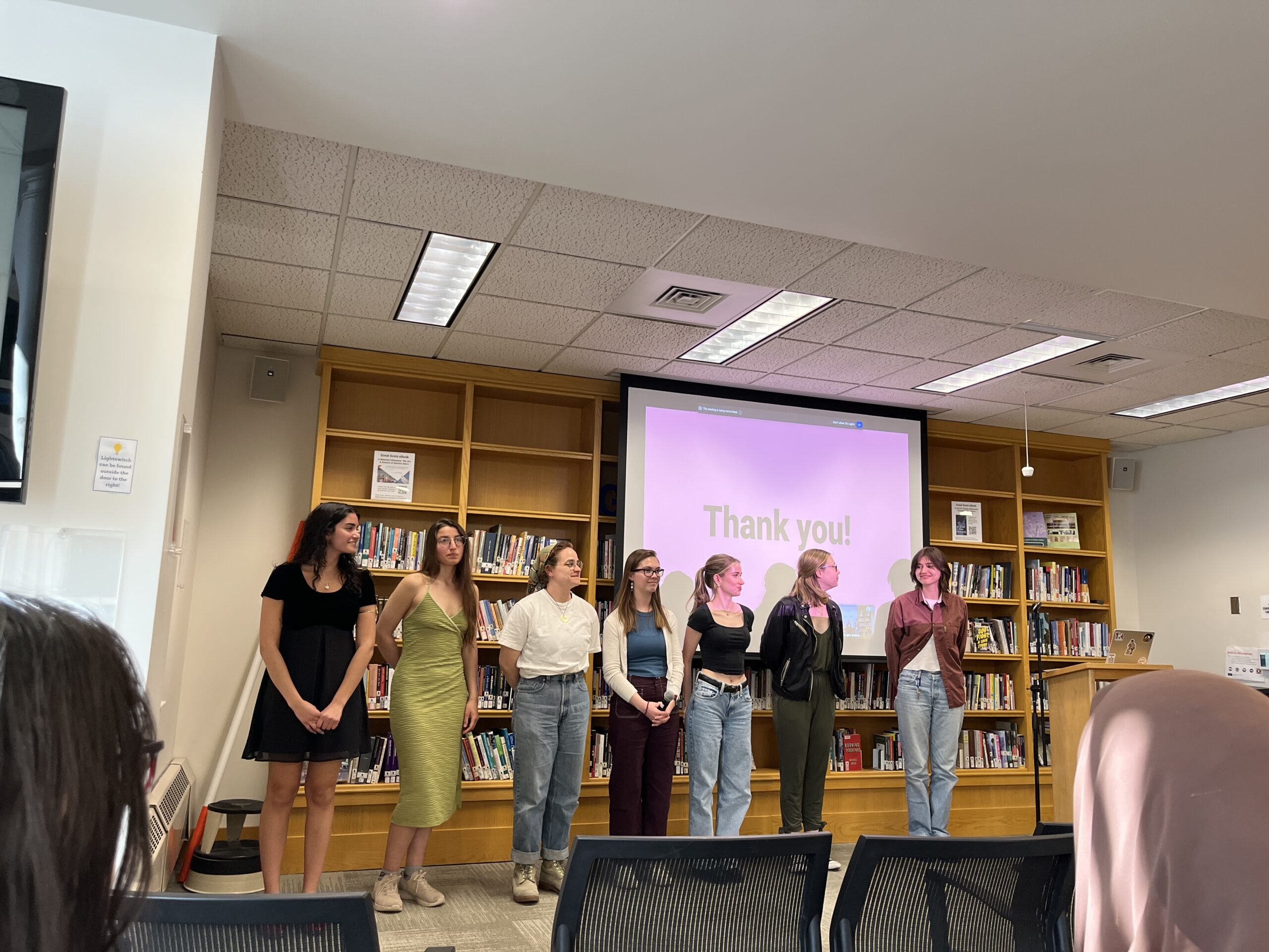 Honors Project presenters stand with capstone presenters stand at the front of the Harmon Room to take questions from the room.