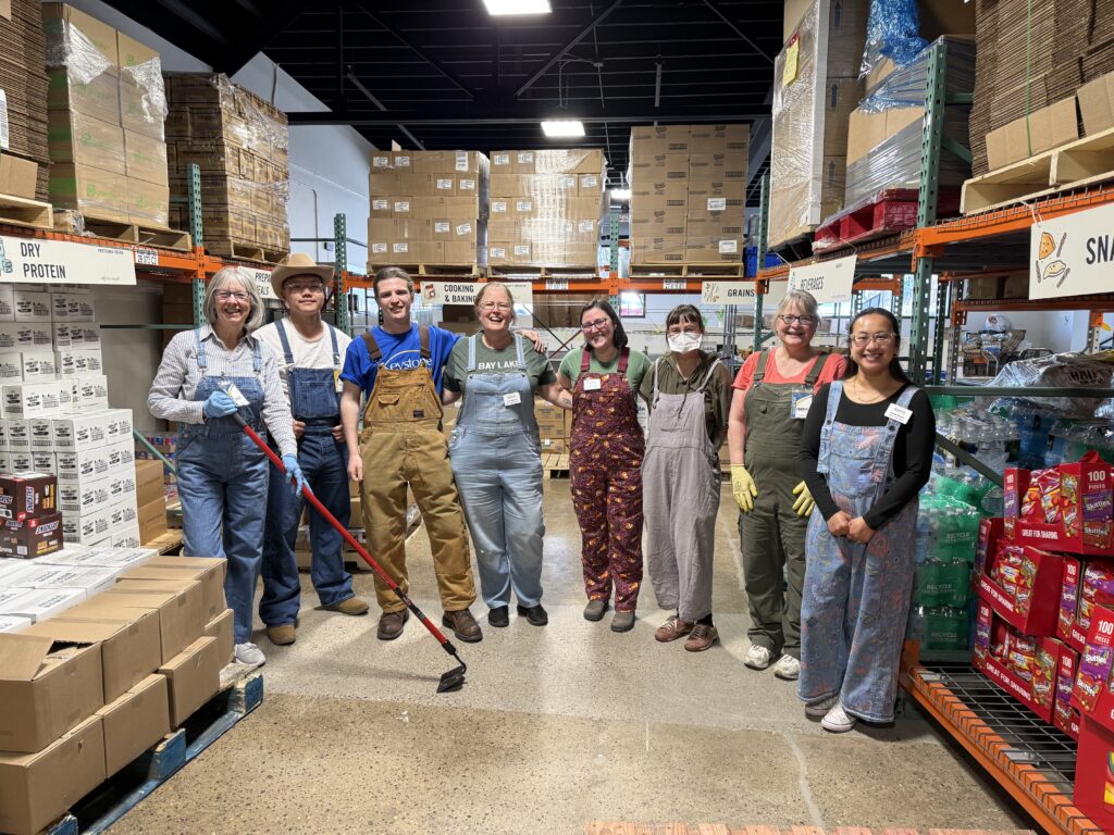 Sophie Hilker '20 poses with her co-workers in front of rows of boxes at Keystone.