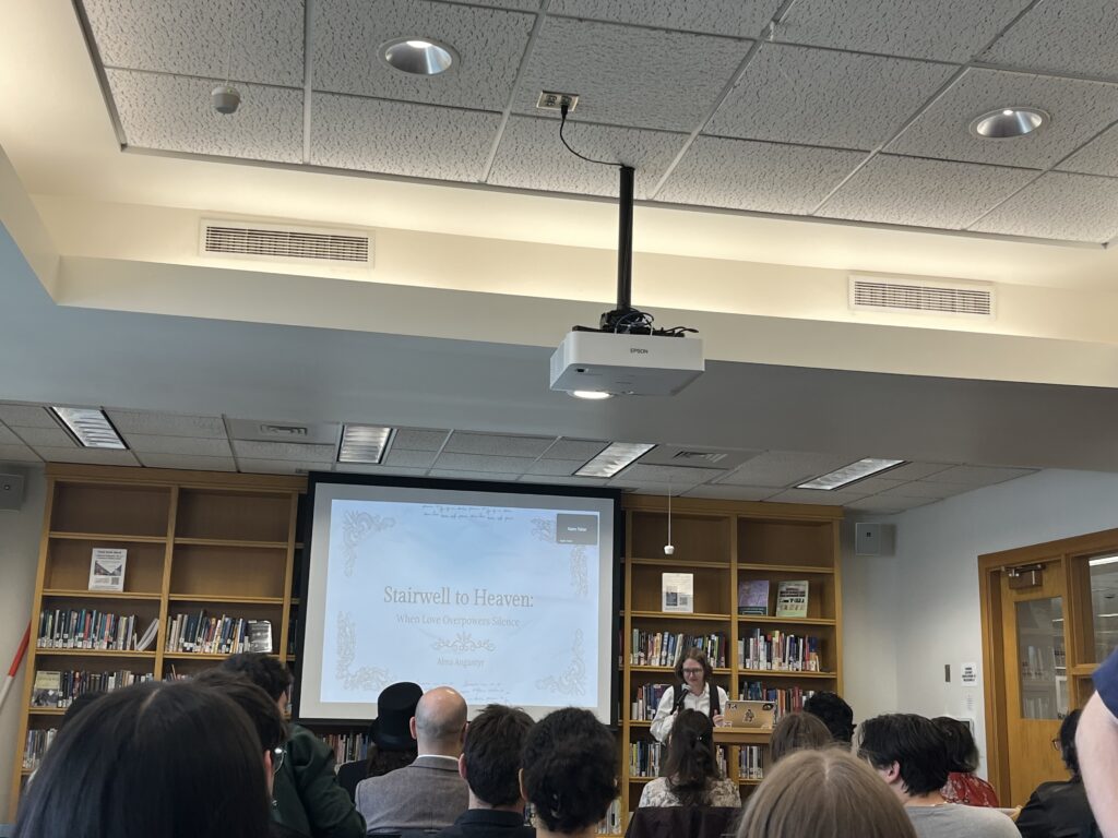 Alma presenting at the front of the Harmon Room 