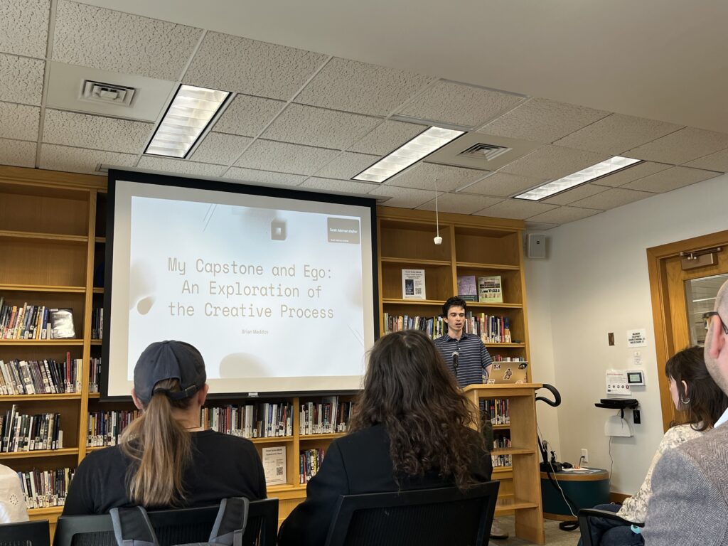Brian presenting at the front of the Harmon Room