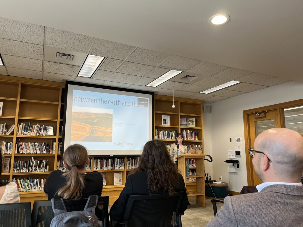 Claire presenting at the front of the Harmon Room