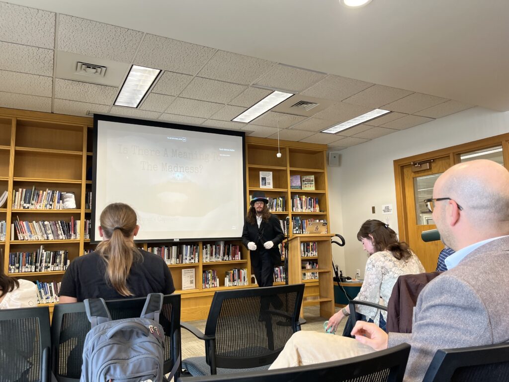 Nicholas presenting at the front of the Harmon Room