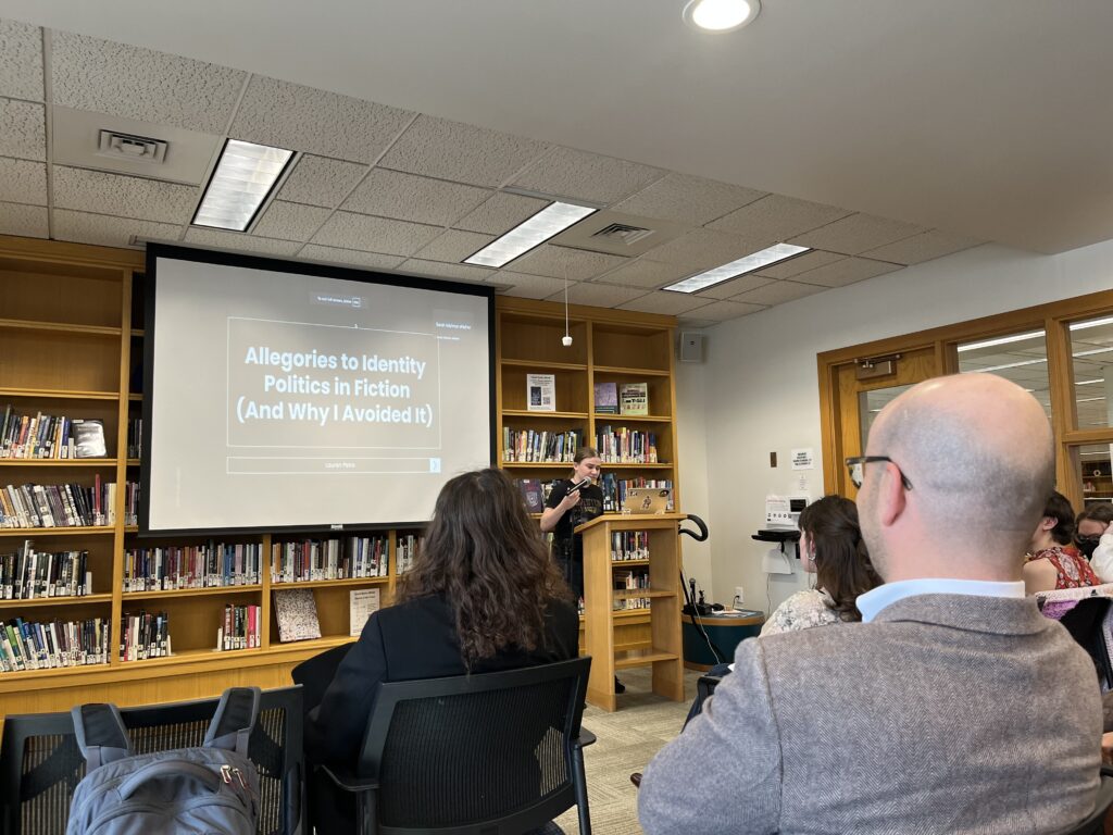 Lauren presenting at the front of the Harmon Room