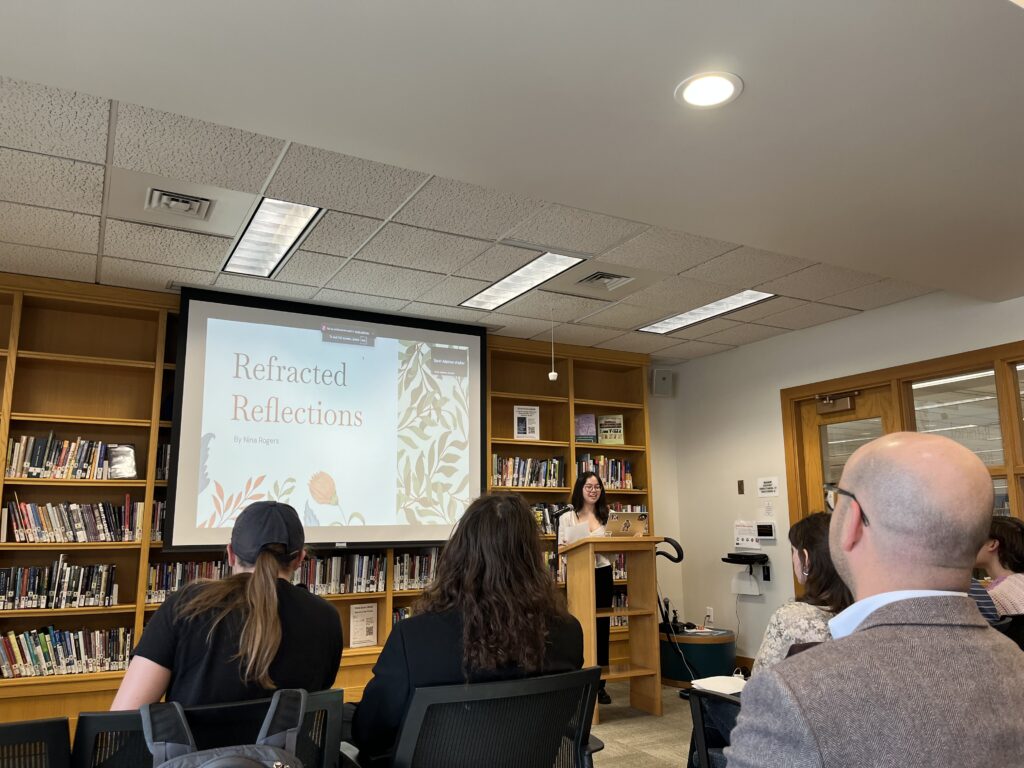 Nina presents at the front of the Harmon Room