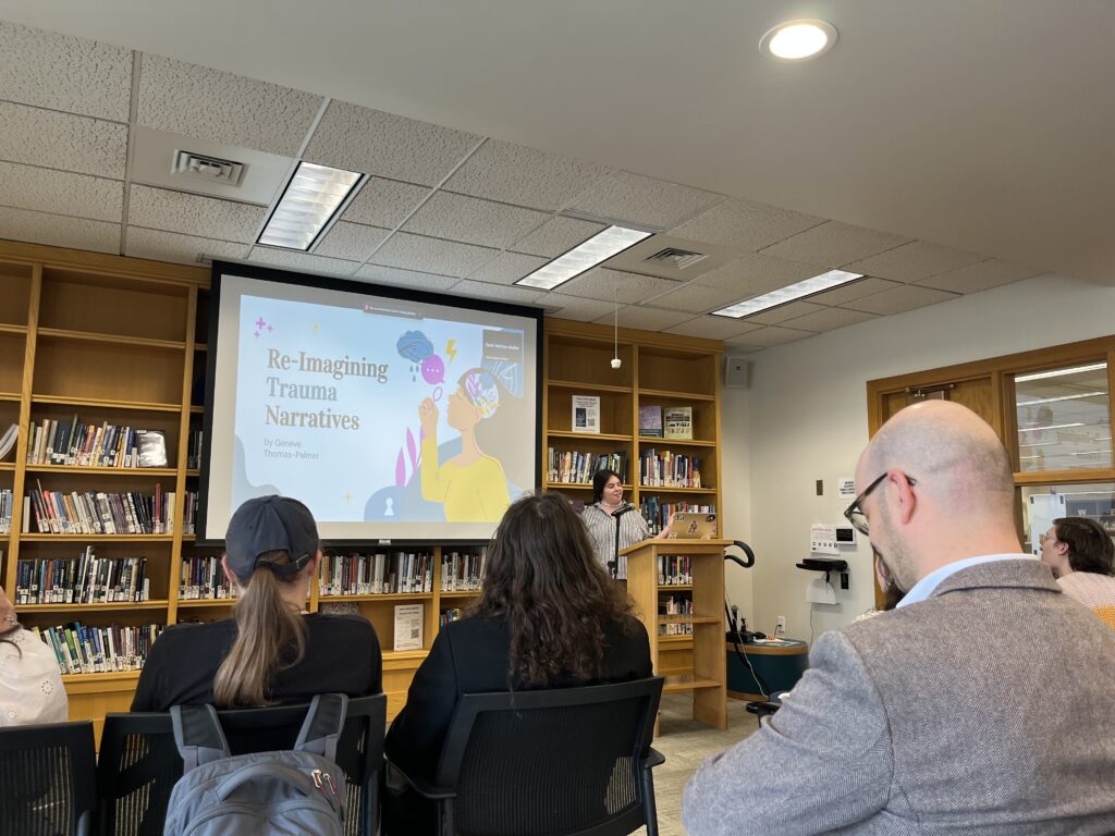 Geneve presenting at the front of the Harmon Room