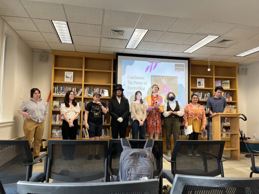 Capstone presenters from Night #1 pose at the front of the Harmon Room in the library before answering questions