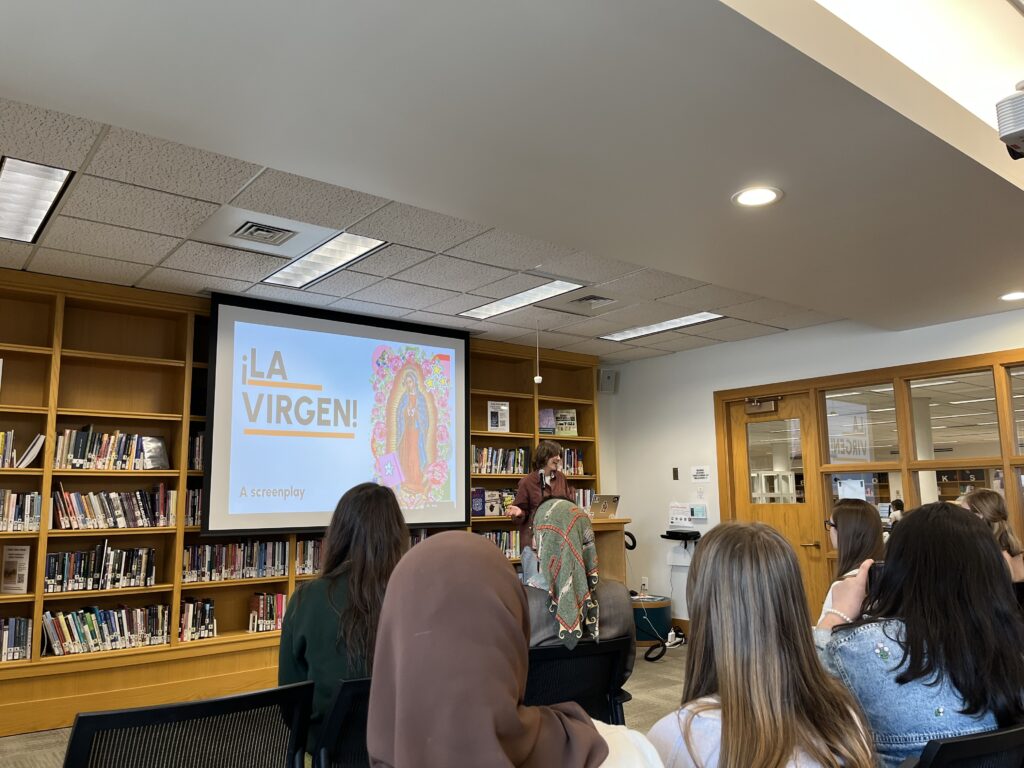 Leyden presents at the front of the Harmon Room