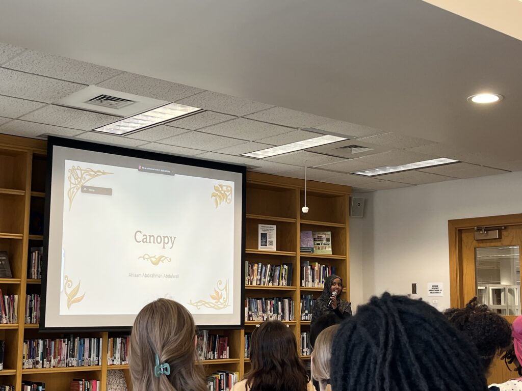 Ahlaam presents at the front of the Harmon Room