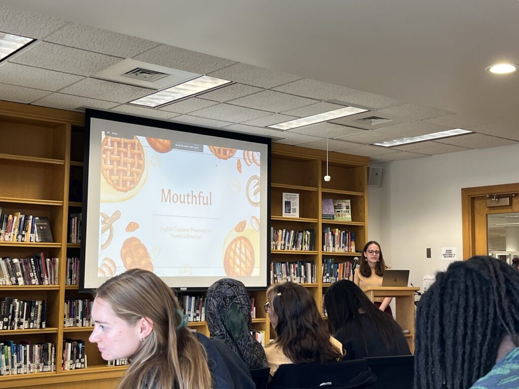 Veronica presents at the front of the Harmon Room