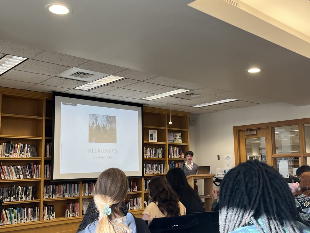 Kai presents at the front of the Harmon Room