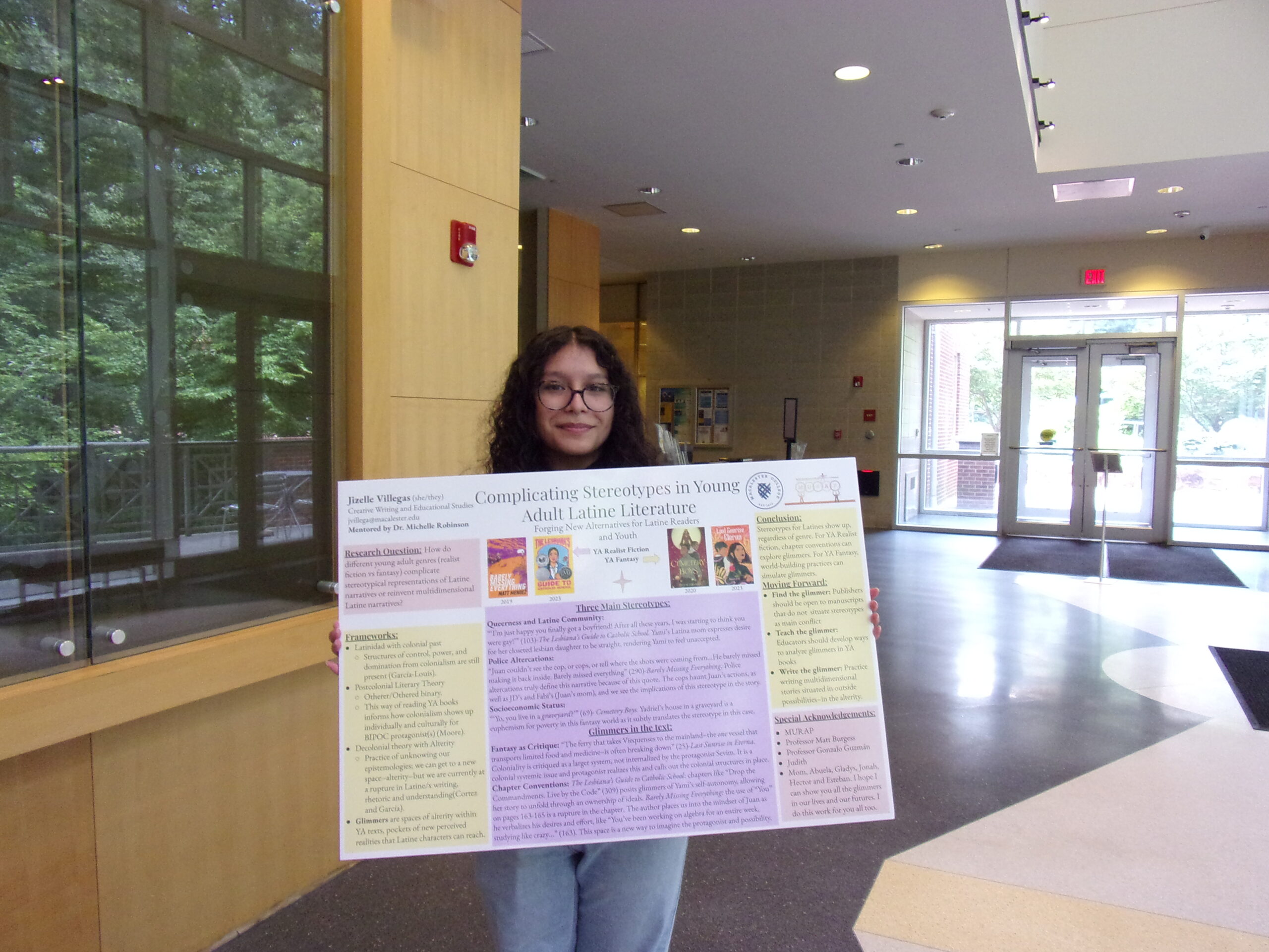 Jizelle Villegas holding a poster board.