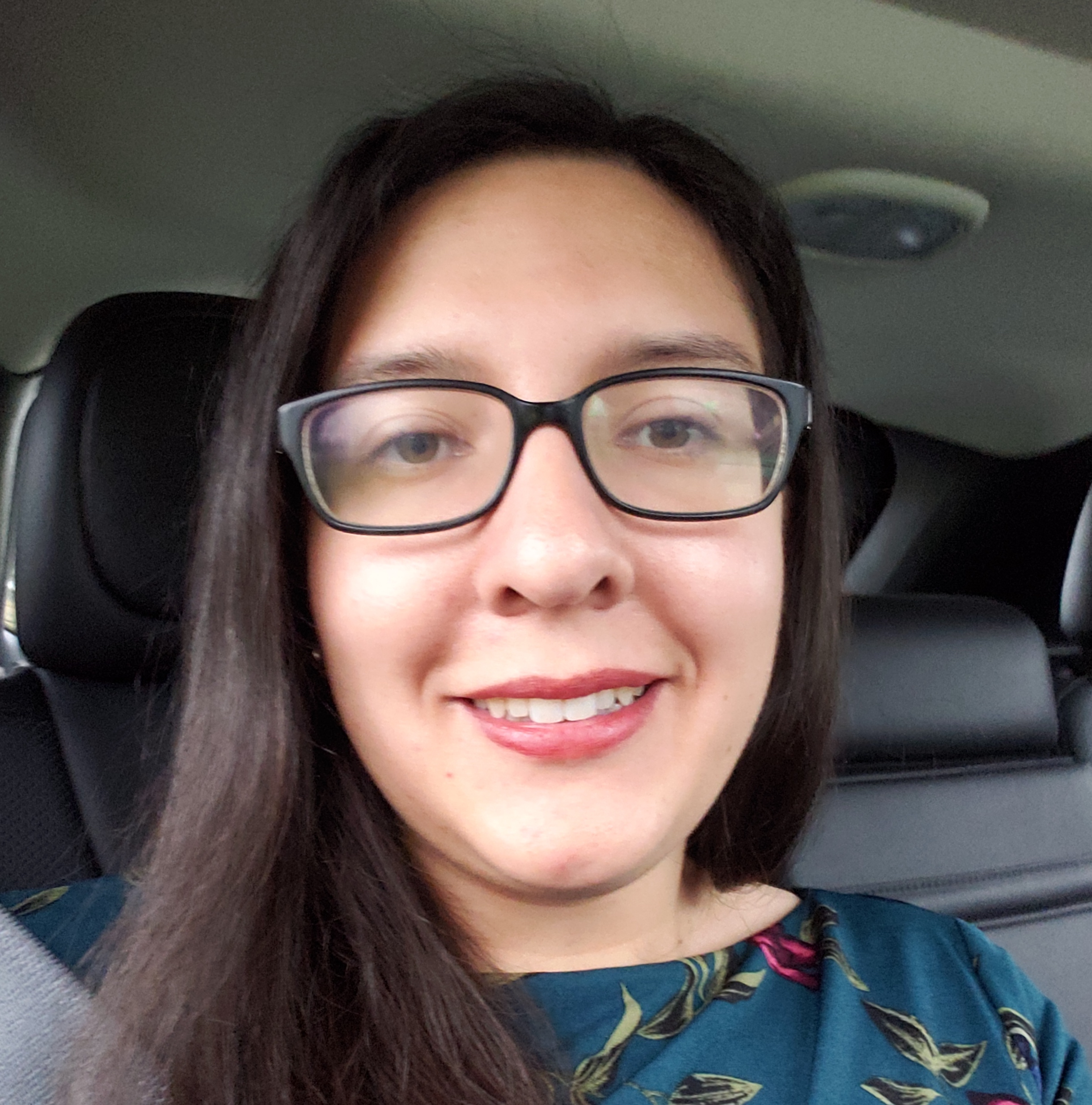 Professor Karen Soto poses for a selfie in the car.