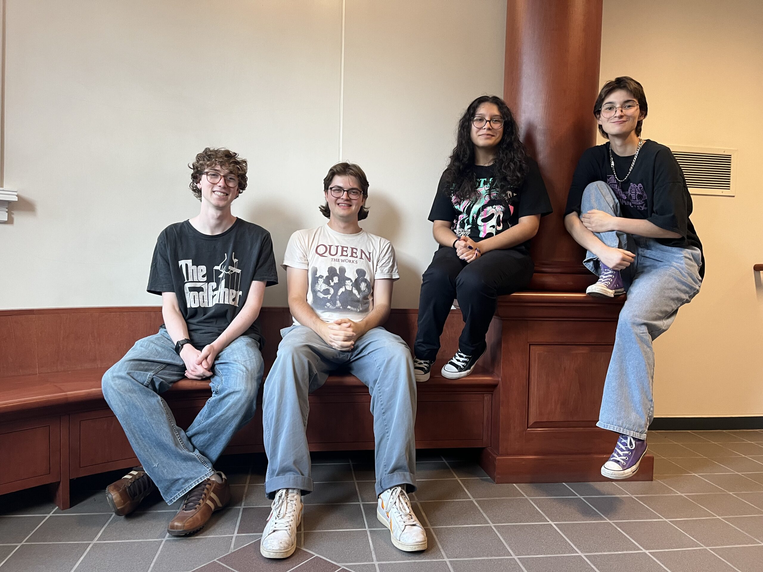 Senior Newsletter Editors pose on Old Main bench. Left to right: Paul Wallace '27, Daniel Graham '26, Jizelle Villegas '26, and Callisto Martinez '26