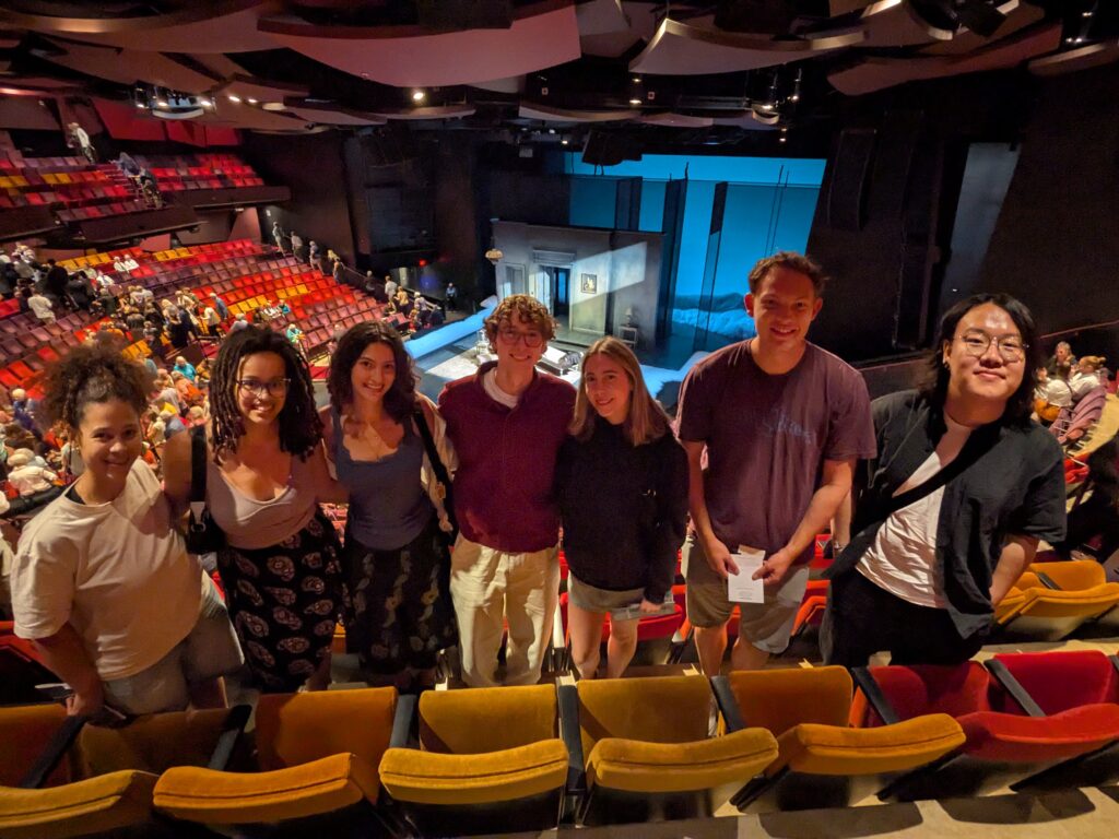 Macalester students and friends at the Guthrie Theater in front of the set of A Doll's House