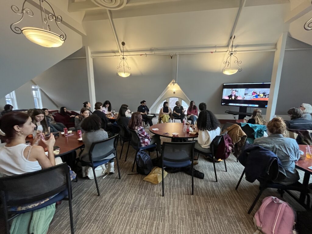 Students sitting in Old Main 4th floor lounge listening to the alumni panel.