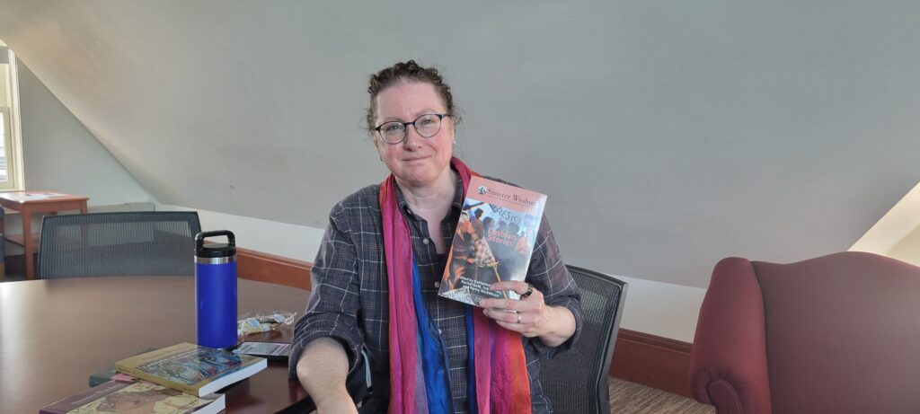 Prof. Gold with newest issue of Sinister Wisdom