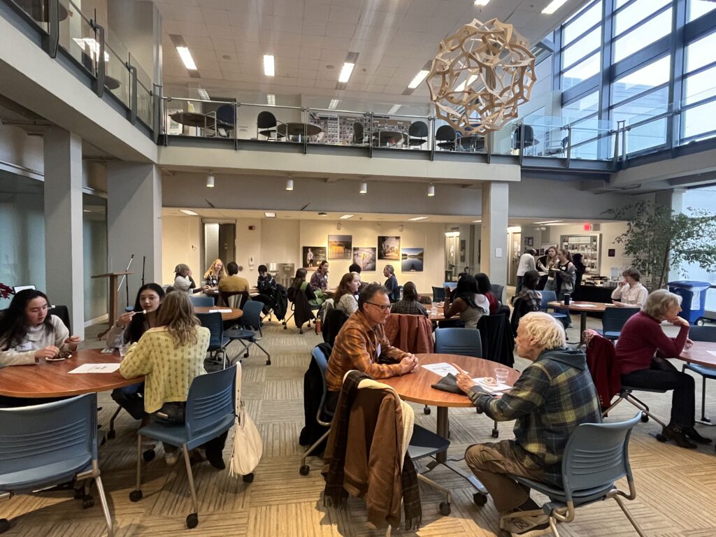 Alumni of all ages and current students gather together in groups in Smail Gallery in Olin-Rice.
