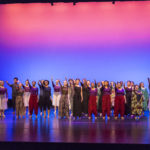 Many dancers salute the lighting booth on stage
