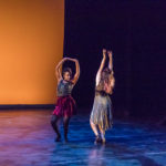 Two dancers spin on stage