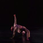 A dance bends backwards on stage