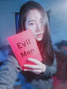 The author holding a copy of Evil Men by James Dawes