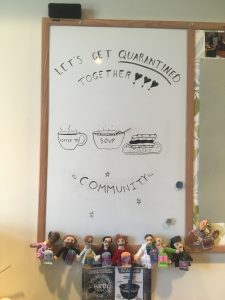 sign in the english department reading "let's get quarantined together" and "community"