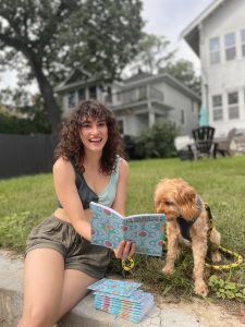 Miriam Moore-Keish reads Clearance Philosophy with her dog.