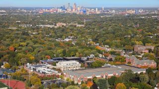 Aerial photo with the Macalester campus in the foreground and downtown in the background.