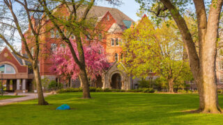 The Great Lawn in spring at Macalester. Old Main is visible in the background.