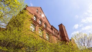 A low angle shot of Old Main in the sunlight